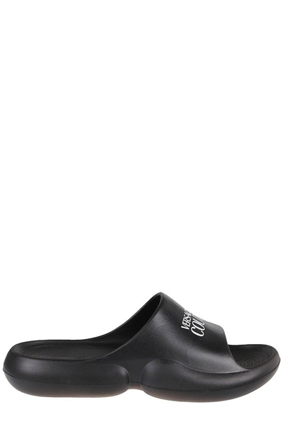 Shop Versace Jeans Couture Logo Printed Round Toe Slides In Black