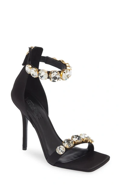 Shop Versace Crystal Embellished Ankle Strap Sandal In Black/ Gold