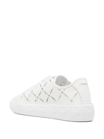 Shop Versace Slashed Leather Sneakers In White