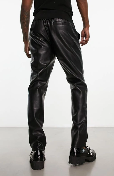 Shop Asos Design Relaxed Fit Lace-up Faux Leather Trousers In Black