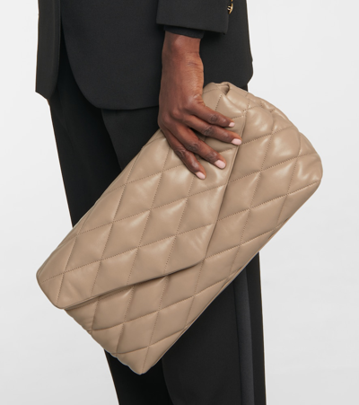 Shop Saint Laurent Sade Puffer Quilted Leather Clutch In Beige