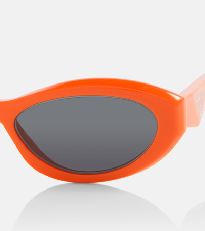 Shop Prada Symbole Oval Sunglasses In Orange