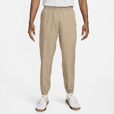 Shop Nike Men's Form Dri-fit Tapered Versatile Pants In Brown