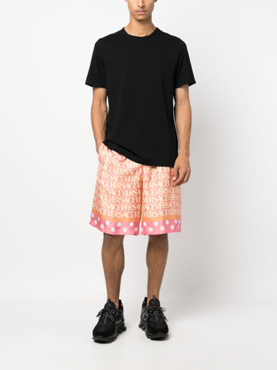 Shop Versace Allover Logo-print Silk Shorts In Rosa