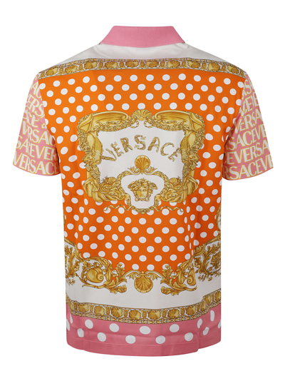 Shop Versace All-over Logo Polo Shirt In Pink/ivory
