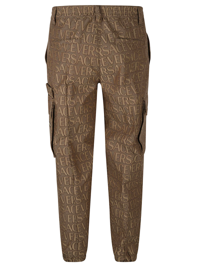 Shop Versace Informal Techno Canvas Trousers In Brown/beige