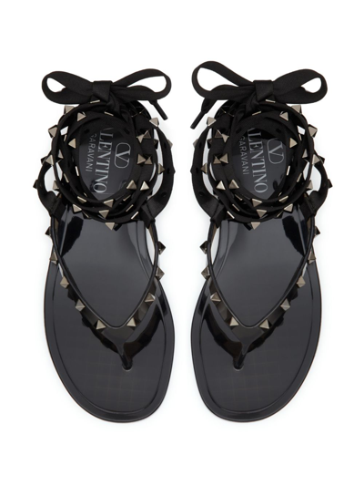 Shop Valentino Rockstud Flat Lace-up Thong Sandals In Black