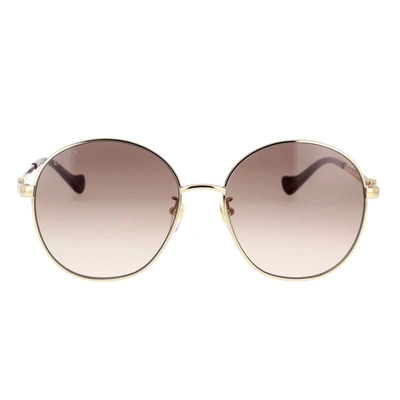 Shop Gucci Eyewear Sunglasses In Gold