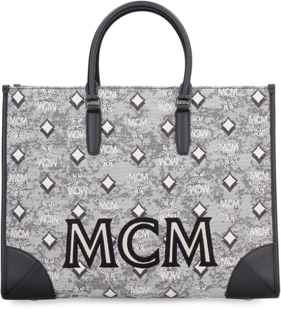 Shop Mcm All Over Logo Canvas Tote In Grey