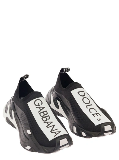 Shop Dolce & Gabbana 'sorrento' Black Slip-on Sneakers With Contrasting Logo Print In Stretch Mesh Woman