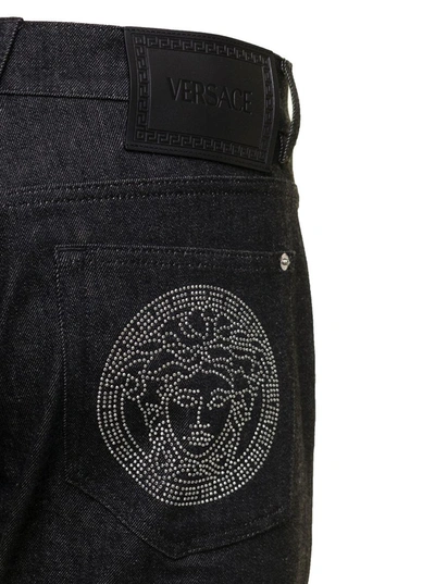 Shop Versace Black Straight Jeans With Studded Medusa In Stretch Cotton Denim Man