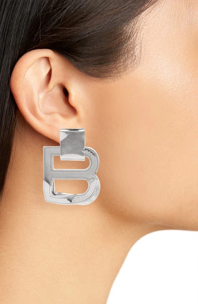 Shop Balenciaga Hourglass Logo Drop Earrings In Silver