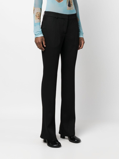 Shop Acne Studios Low-rise Flared Trousers In Schwarz