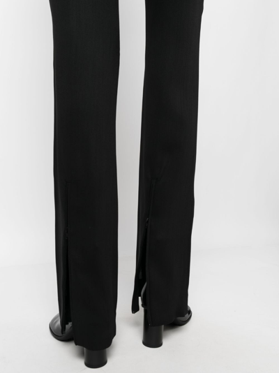 Shop Acne Studios Low-rise Flared Trousers In Schwarz