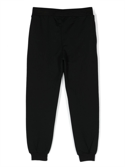 Shop Moschino Black Track Pants And Contrasting Maxi Logo In Stretch Cotton Boy