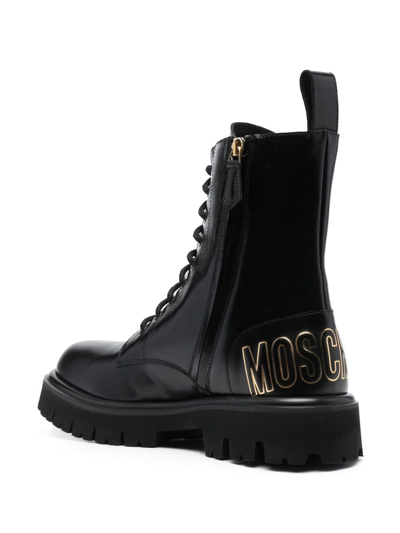 Shop Moschino Logo-embossed Ankle Boots In Black