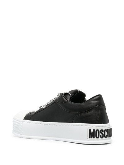 Shop Moschino Embossed-logo Faux-leather Sneakers In Black
