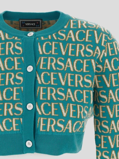 Shop Versace All Over Logo Knit Cropped Cardigan In Turquoise+light Blue