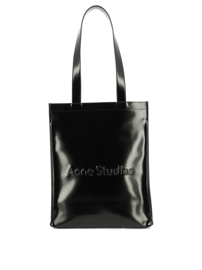 Shop Acne Studios Logo Embossed Top Handle Bag In Black
