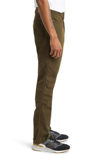 Shop Duer No Sweat Relaxed Tapered Performance Pants In Army Green