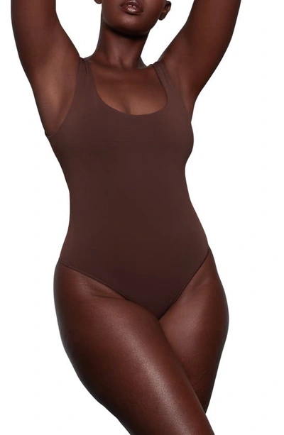 Shop Skims Soft Smoothing Thong Bodysuit In Cocoa