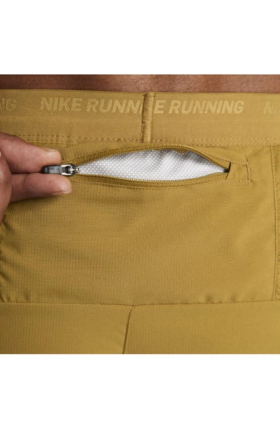 Shop Nike Dri-fit Stride 5-inch Running Shorts In Bronzine/ Buff Gold