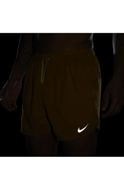 Shop Nike Dri-fit Stride 5-inch Running Shorts In Bronzine/ Buff Gold