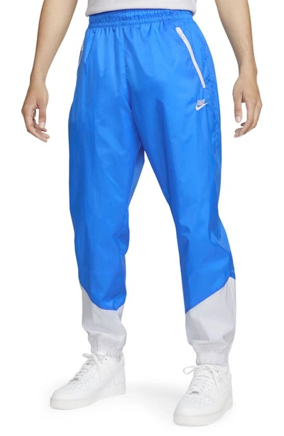 Shop Nike Windrunner Woven Lined Pants In Photo Blue/ White/ White