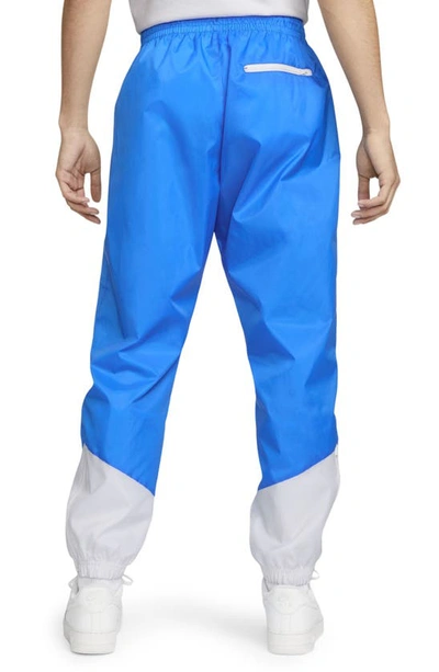 Shop Nike Windrunner Woven Lined Pants In Photo Blue/ White/ White