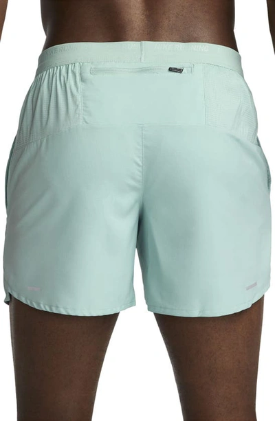 Shop Nike Dri-fit Stride 5-inch Running Shorts In Mineral/ Jade Ice
