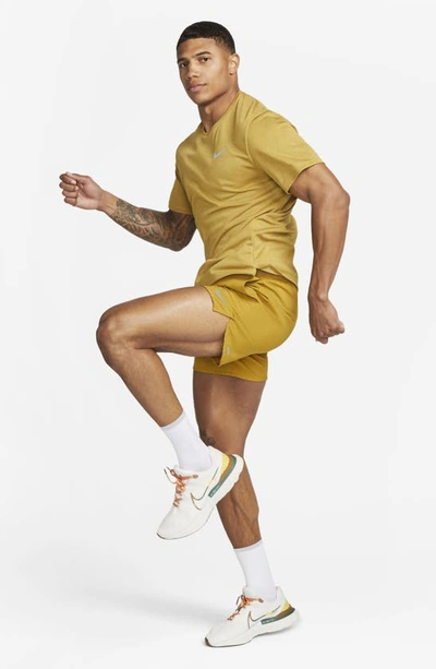 Shop Nike Dri-fit Stride 7-inch Brief-lined Running Shorts In Bronzine/ Buff Gold