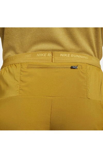Shop Nike Dri-fit Stride 7-inch Brief-lined Running Shorts In Bronzine/ Buff Gold