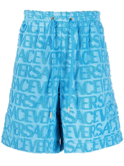 Shop Versace Light Blue Bermuda Shorts With Embossed Logo