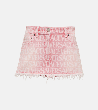 Shop Versace Allover Denim Miniskirt In Pink