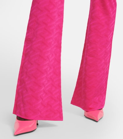 Shop Versace La Greca High-rise Flared Pants In Pink