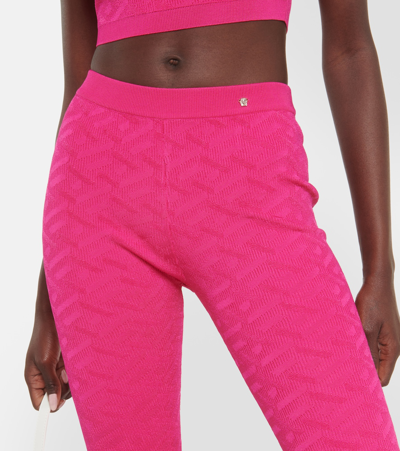 Shop Versace La Greca High-rise Flared Pants In Pink