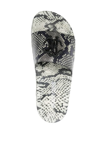 Shop Roberto Cavalli Snakeskin-effect Slides In White