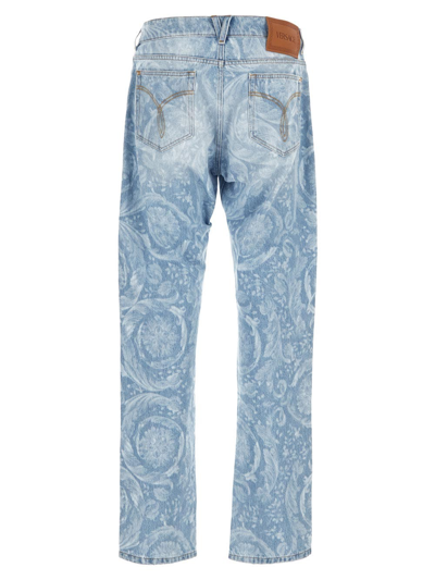 Shop Versace All-over Logo Jeans In Blue