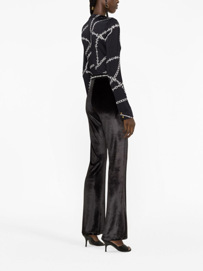 Shop Versace Jeans Couture Logo Waistband Flared Trousers In Black