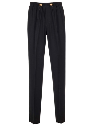 Shop Versace Drawstring Pleated Trousers In Black