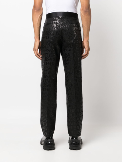 Shop Versace Allover Jacquard Trousers In Black