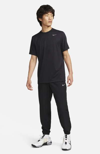 Shop Nike Dri-fit Tapered Versatile Pants In Black/ Silver