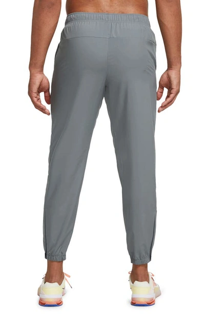 Shop Nike Dri-fit Tapered Versatile Pants In Smoke Grey/ Black/ Silver