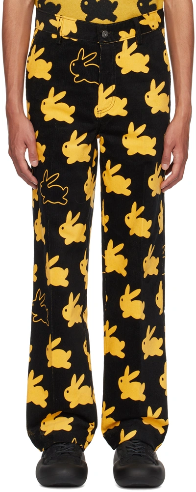 Shop Jw Anderson Black & Yellow 'all Over Bunny' Trousers In Black/yellow