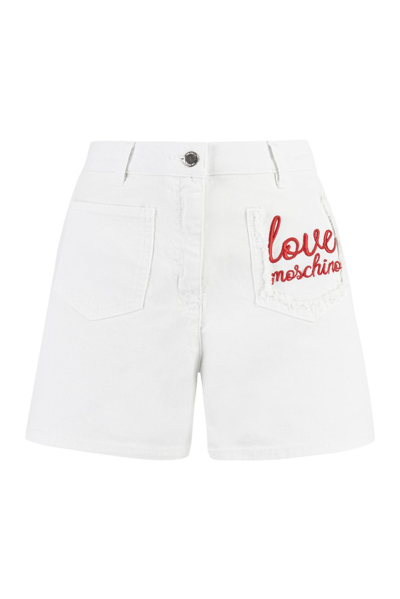 Shop Love Moschino Logo Embroidered Denim Shorts In White
