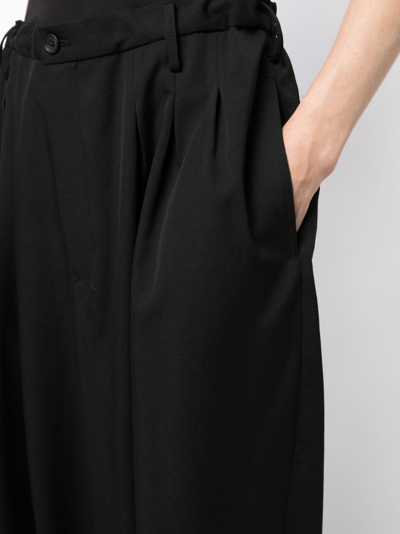 Shop Yohji Yamamoto Tapered-leg Pleat-detail Trousers In Black
