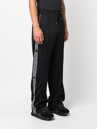 Shop Versace Allover Pattern Track Pants In Black