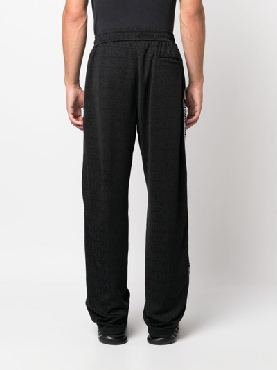 Shop Versace Allover Pattern Track Pants In Black