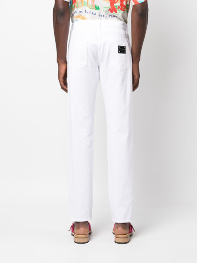 Shop Dolce & Gabbana Ripped-detail Tapered-leg Jeans In White