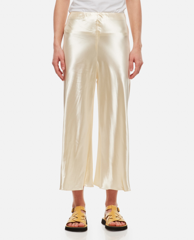 Shop Khaite Toni High Waisted Fluid Viscose Trousers In Golden